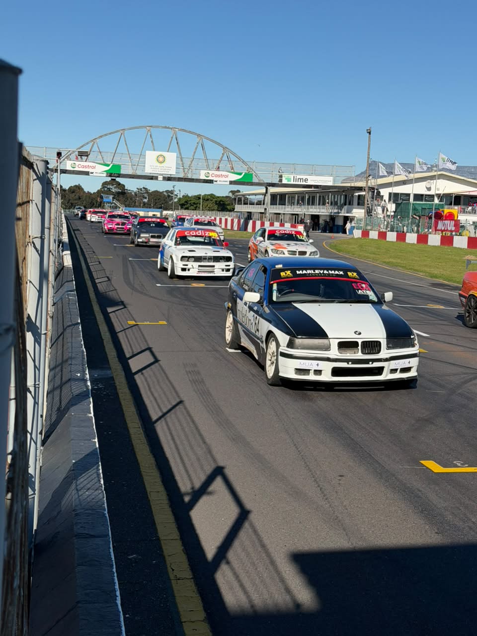 Blue-and-white BMW E36 displaying E81 on the windscreen